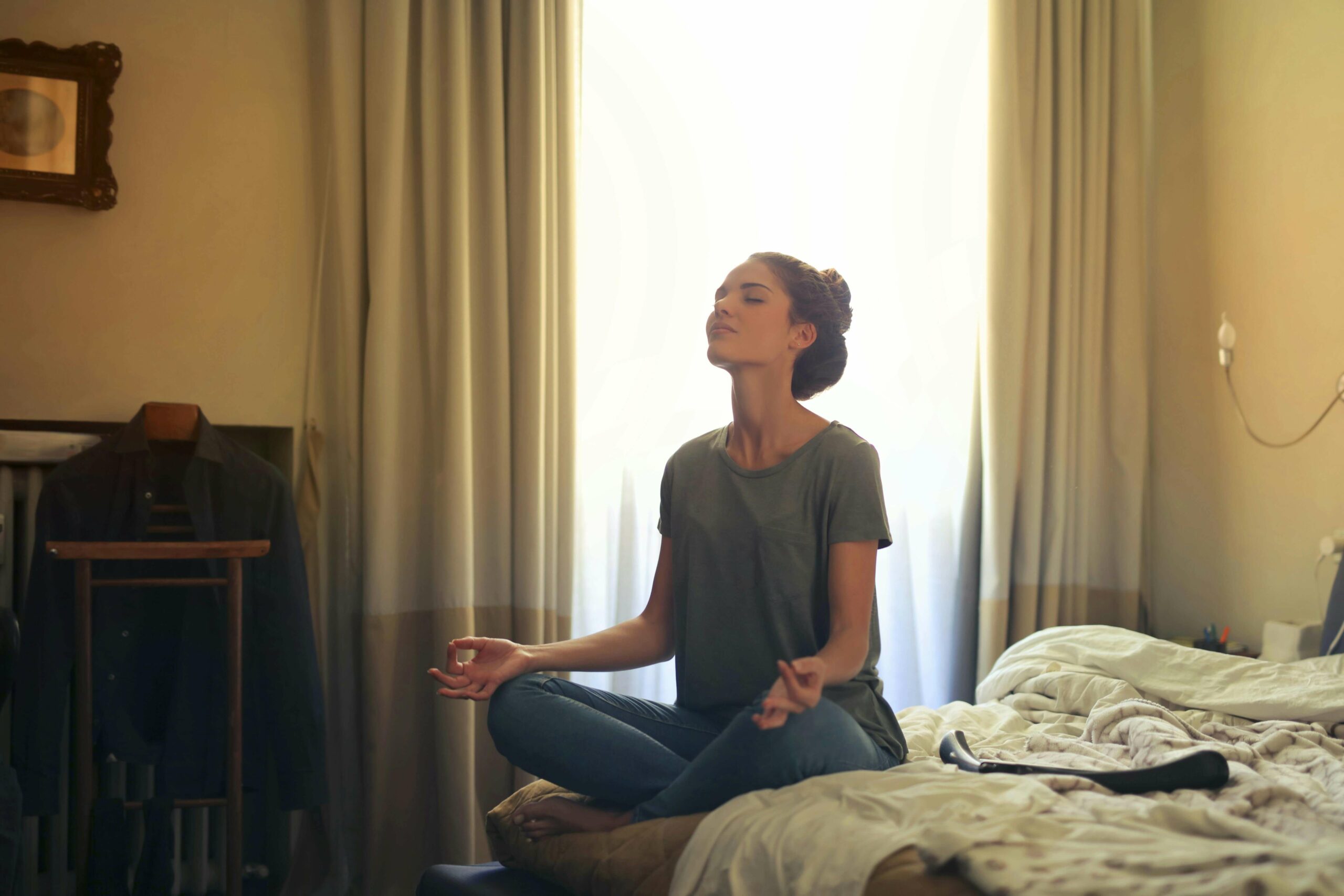 Women Meditating in Bedroom